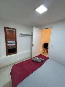 a bedroom with a large bed and a window at Loftt concept in Rio de Janeiro