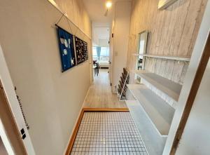 a hallway of a house with empty shelves and a tile floor at HOTTOSTAYman401 in Sasashimachō +20 photos