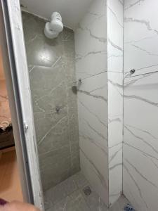 a shower with a glass door in a bathroom at Loftt concept in Rio de Janeiro