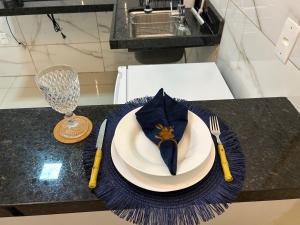 a plate with a napkin on a table with a cake at Loftt concept in Rio de Janeiro