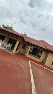 a house with a tennis court in front of it at Ntale Guest House in Benoni