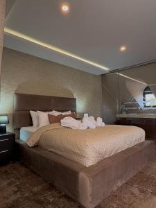 a bedroom with a large bed with towels on it at Guest House Panorama Aqualux with Free Parking in Novi Sad +93 photos
