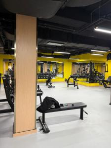a gym with a table in the middle of a room at Ugam Mountain apartments in Khumson