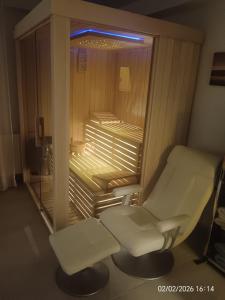 a hospital room with a white chair and a window at Luxury Apartment Saya in Banja Luka
