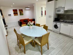 a kitchen and living room with a table and chairs at SunRise in Santa Maria +6 photos