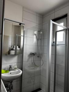 a bathroom with a shower and a sink at Ferienwohnung Chiara in Mettlach +7 photos