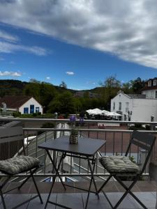 a table and two chairs on a balcony at Ferienwohnung Chiara in Mettlach
