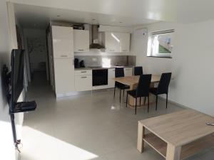 a kitchen and dining room with a table and chairs at Le Paradis d'Ayli in Aywaille +18 photos