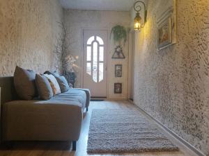 a living room with a couch and a door at In House in Tbilisi City