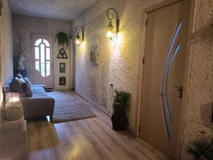 a living room with a couch and an open door at In House in Tbilisi City