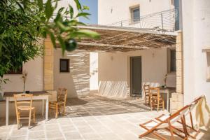 a patio with chairs and a table and a table and chairsktop at Corte Sant'Oronzo in Diso