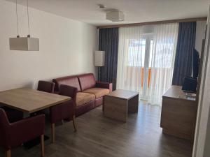 a living room with a couch and a table at Apartment 117 in Feldberg