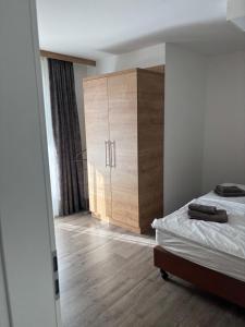 a bedroom with a bed and a wooden cabinet at Apartment 117 in Feldberg