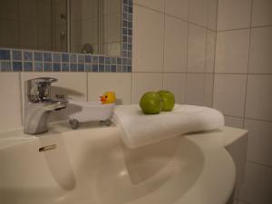 a bathroom with a sink with two apples on it at Hotel Seiserhof & Seiseralm in Bernau am Chiemsee +55 photos