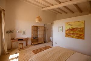 a bedroom with a bed and a desk at Casa Imayah charming B&B in Noto