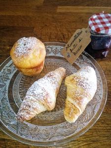 two pastries and a donut on a plate on a table at B&B ai SILIO in La Morra +43 photos