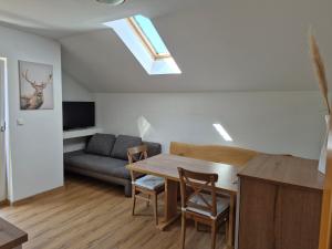 a living room with a table and a couch at Ferienhof Edtmeier in Zell am Moos