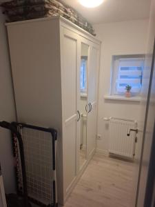 a hallway with a white door and a window at Ferienwohnung Alte Glaserei in Ilsenburg