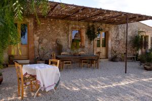 a patio with a table and chairs in front of a building at Casa Imayah charming B&B in Noto