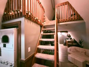a staircase in a house with a washer and dryer at Romantic A-frame HeartJacuzzi Firepit Kayaks in Warsaw