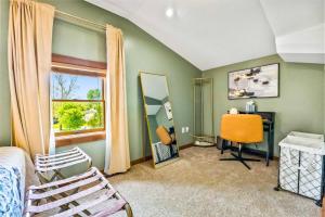 a bedroom with a bed and a desk and a window at Romantic A-frame HeartJacuzzi Firepit Kayaks in Warsaw
