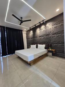 a bedroom with a bed and a ceiling fan at Omex hazratganj arjunganj in Nalmatha