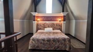 a bedroom with a bed with a floral bedspread at Villa Jurmala in Jūrmala