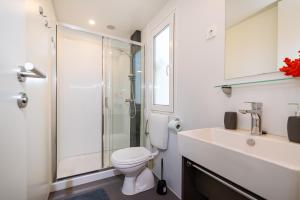 a bathroom with a shower and a toilet and a sink at House no 3 in Pakoštane +12 photos