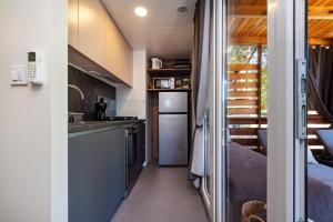a kitchen in a tiny house with the door open at House no 3 in Pakoštane