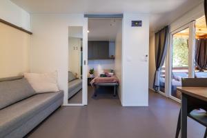 a living room with a couch and a bedroom at House no 3 in Pakoštane
