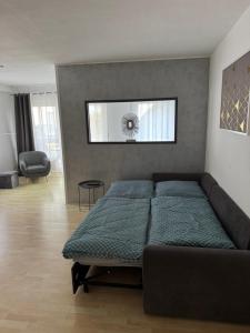 a bedroom with a bed and a couch at Appartement by Luis in Burgheim