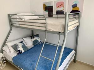 a bunk bed in a room with pillows on a bunk bed at Casa Teuwisse in Torre-Pacheco
