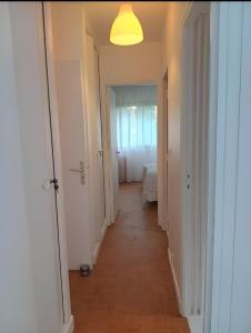 a hallway with a hallway leading to a bedroom at La Précieuse, RER A Proche Paris in Saint-Maur-des-Fossés +40 photos