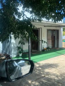 a side view mirror of a house with a green lawn at The Nest- on Knowling Street in Grahamstown