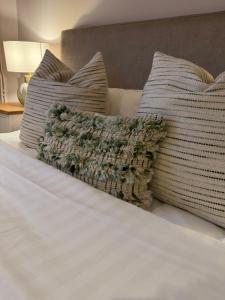 a bed with two pillows and a blanket on it at The Hare and Hounds in Fulbeck