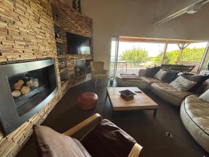 a living room with a couch and a fireplace at VILLA Cala D'orzu in Coti-Chiavari