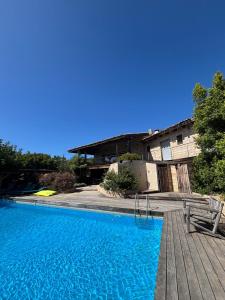 a swimming pool in front of a building at VILLA Cala D'orzu in Coti-Chiavari