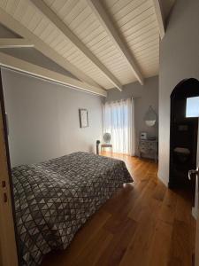 a bedroom with a bed and a wooden floor at VILLA Cala D'orzu in Coti-Chiavari +22 photos