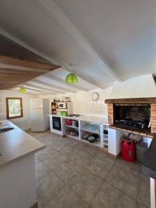a large kitchen with a stove and a counter at VILLA Cala D'orzu in Coti-Chiavari