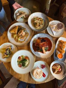 a wooden table with plates of food on it at The Hare and Hounds in Fulbeck +4 photos
