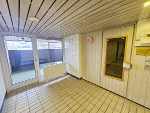 an empty room with a window and a tiled floor at Ferienwohnung Sunset - Traumhafter Seeblick & Sauna in Steinhude in Wunstorf +20 photos