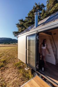 a person standing in the door of a trailer at Glamping Silverboy in Toužim
