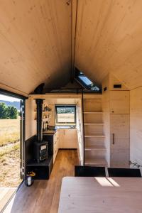 an interior view of a tiny house with a stove at Glamping Silverboy in Toužim