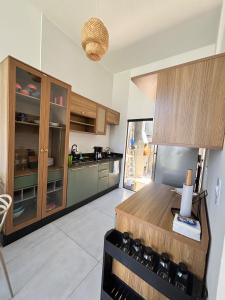 a kitchen with wooden cabinets and a counter top at Beach house in Matinhos in Matinhos +9 photos