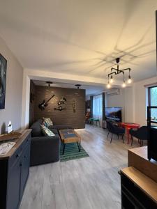 a living room with a couch and a table at Best Apartment Scheia in Suceava