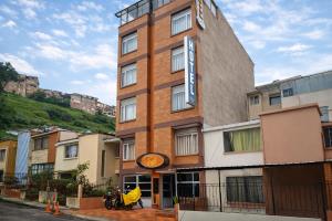 a building with a motorcycle parked in front of it at Hotel Cafe y Miel in Pasto