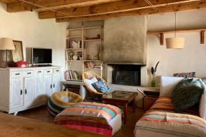 a living room with a couch and a fireplace at Cévennes et Causse Mejean in Dargilan