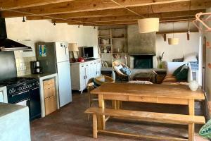 a kitchen with a table and a couch in a room at Cévennes et Causse Mejean in Dargilan