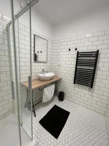 a white bathroom with a sink and a mirror at Apartmány U Jeskyní in Sloup +40 photos