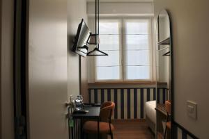 a dining room with a table and a window at HÕMA Certosa District in Milan